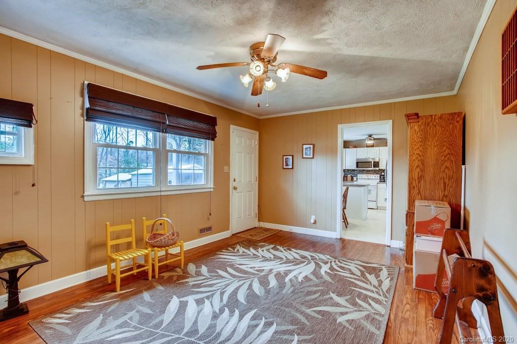 4921 Cheviot Road Charlotte, NC 28269 - Photo 15 of 28 a bedroom with a bed and a chandelier