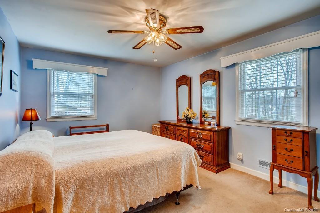 4921 Cheviot Road Charlotte, NC 28269 - Photo 16 of 28 a bedroom with a large bed and a window