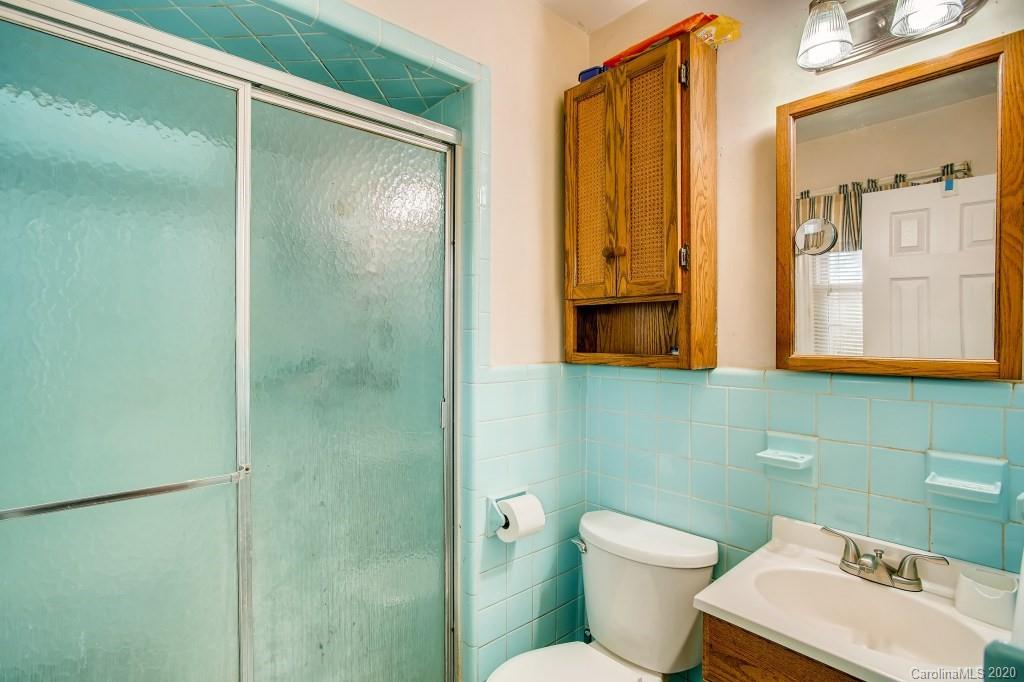 4921 Cheviot Road Charlotte, NC 28269 - Photo 19 of 28 a bathroom with a toilet sink and shower