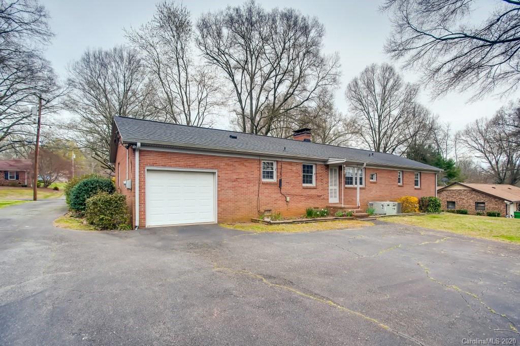 4921 Cheviot Road Charlotte, NC 28269 - Photo 24 of 28 a front view of a house with a yard and garage