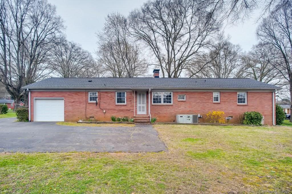 4921 Cheviot Road Charlotte, NC 28269 - Photo 25 of 28 a view of a yard in front of a house with large tree