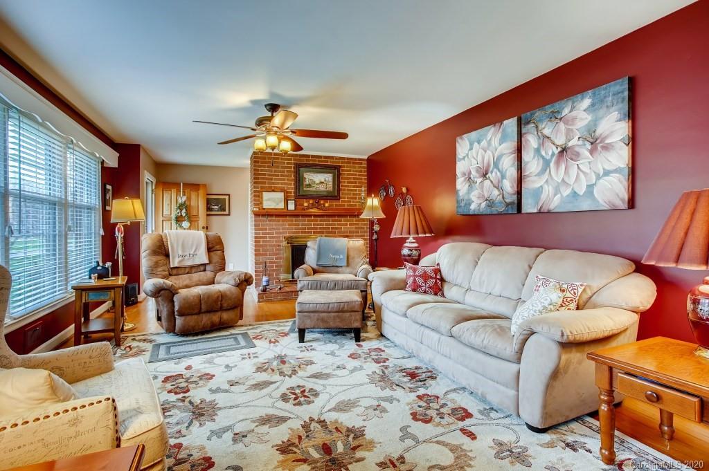 4921 Cheviot Road Charlotte, NC 28269 - Photo 8 of 28 a living room with furniture a rug and a large window
