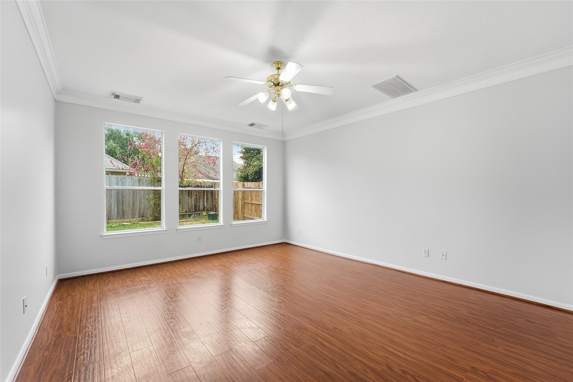 8522 Chickamauga Lane Houston, TX 77083 - Photo 12 of 33 a view of an empty room with wooden floor and a window
