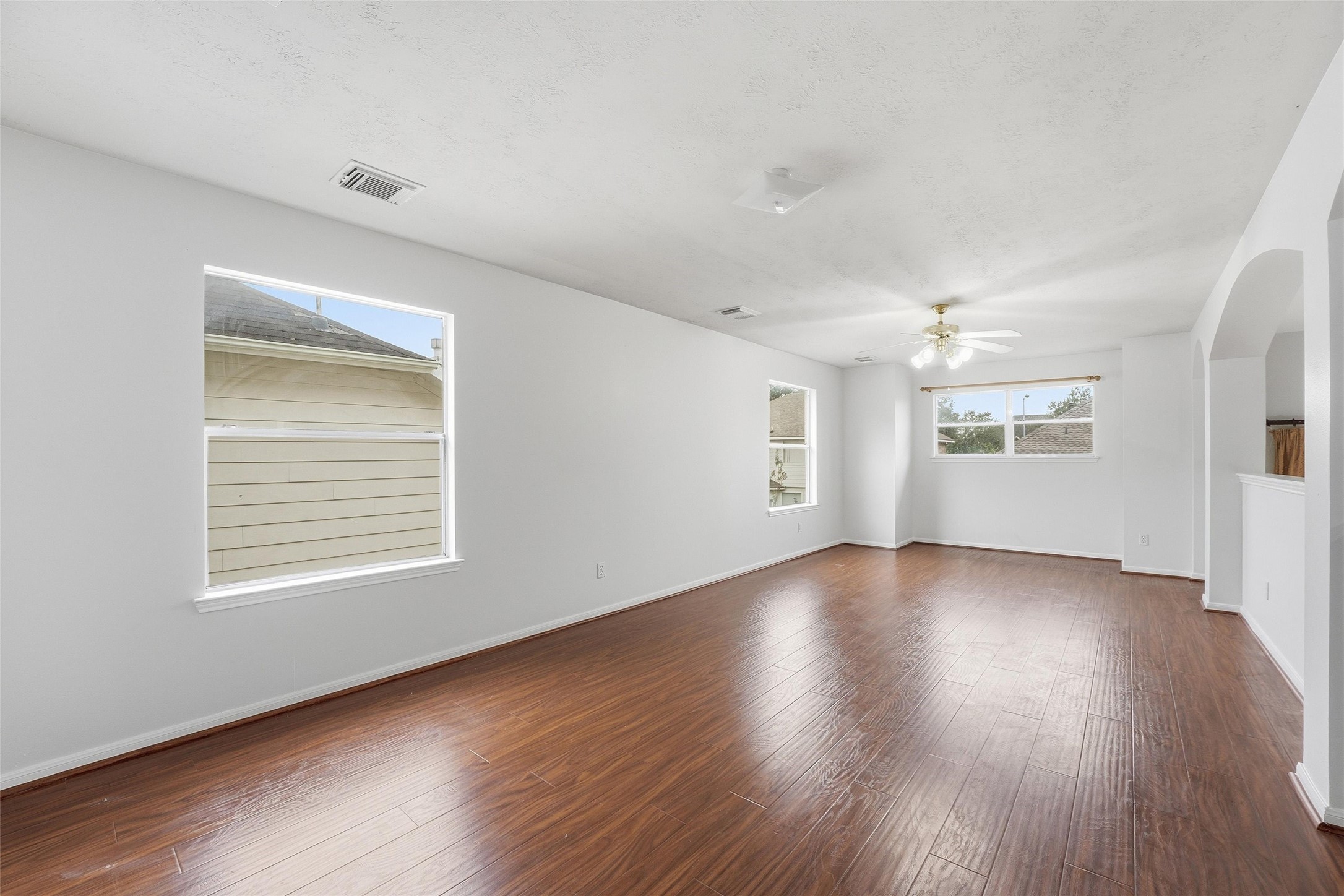 8522 Chickamauga Lane Houston, TX 77083 - Photo 21 of 33 an empty room with wooden floor and windows