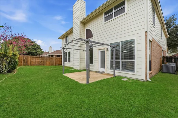 a view of an house with backyard and porch