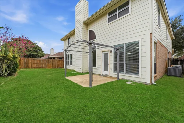 a view of an house with backyard and porch