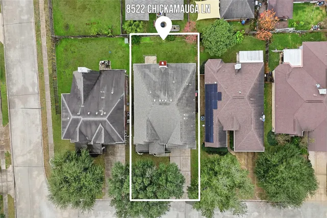 an aerial view of a house with a garden and trees