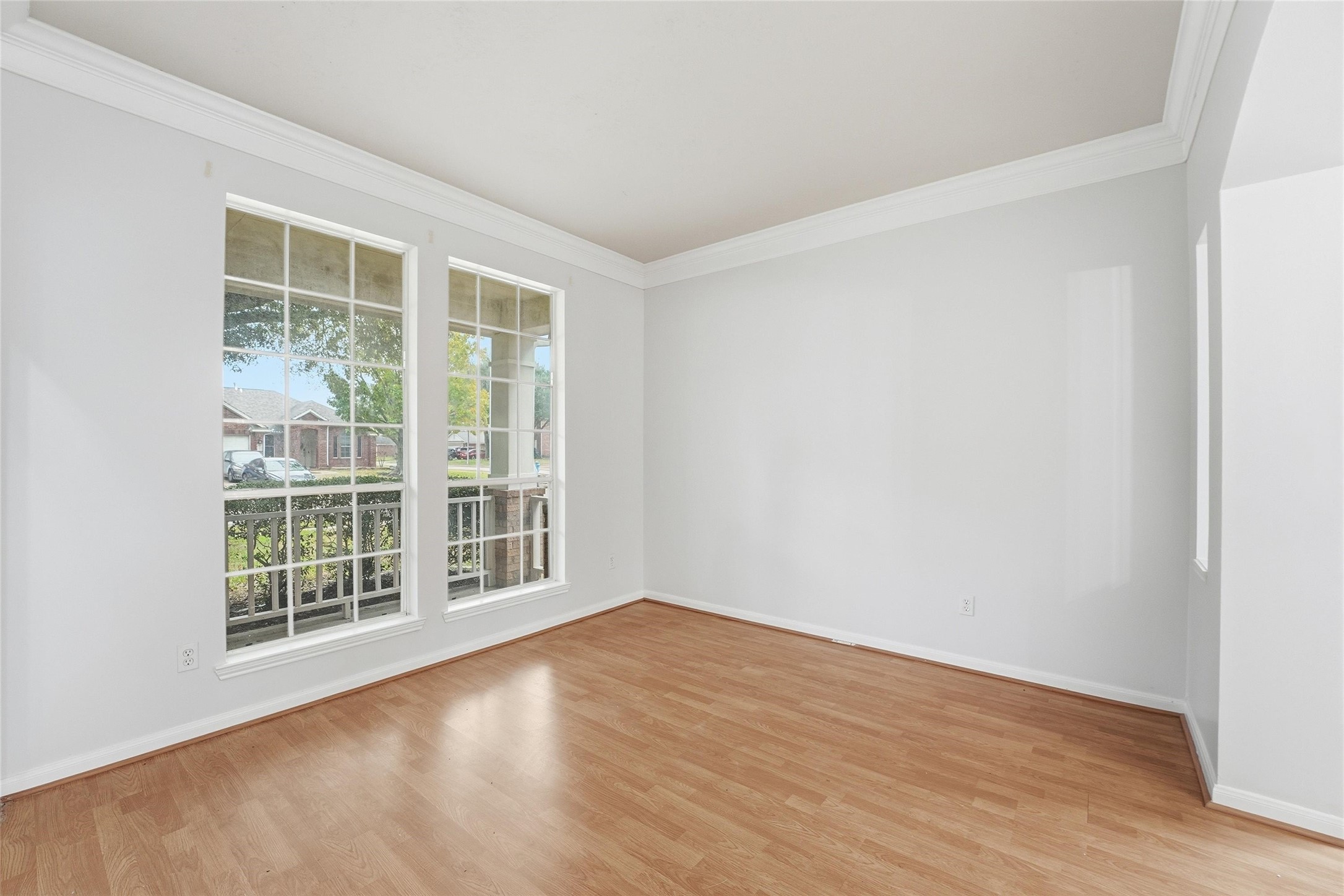 8522 Chickamauga Lane Houston, TX 77083 - Photo 5 of 33 a view of an empty room with wooden floor and a window
