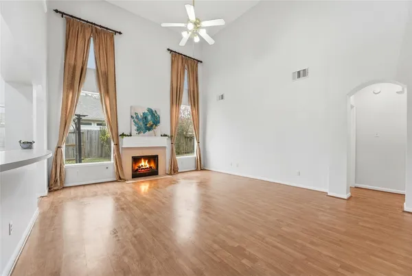 a view of a livingroom with a fireplace and window