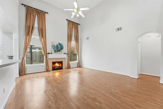 a view of a livingroom with a fireplace and window