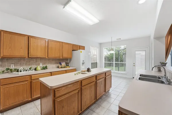 a view of a kitchen with a sink and cabinets
