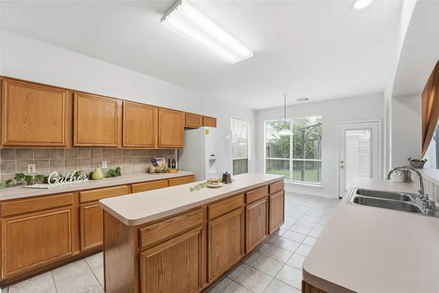 a view of a kitchen with a sink and cabinets