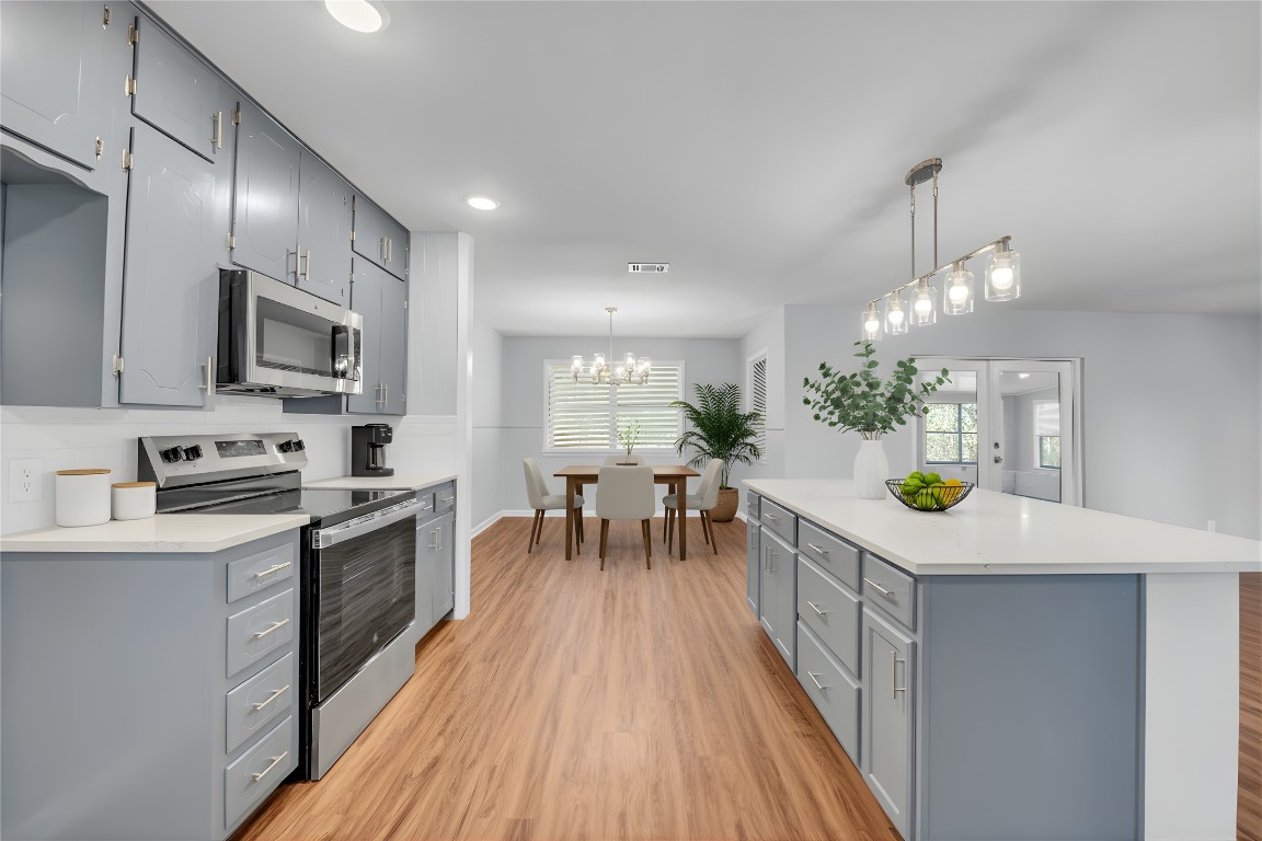 310 Hruskaville Road Temple, TX 76501 - Photo 11 of 21 Kitchen with gray cabinets, stainless steel appliances, hanging light fixtures, light wood-style flooring, and recessed lighting