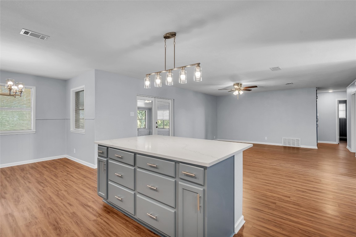 310 Hruskaville Road Temple, TX 76501 - Photo 21 of 21 Kitchen with gray cabinetry, a center island, open floor plan, pendant lighting, and light wood finished floors