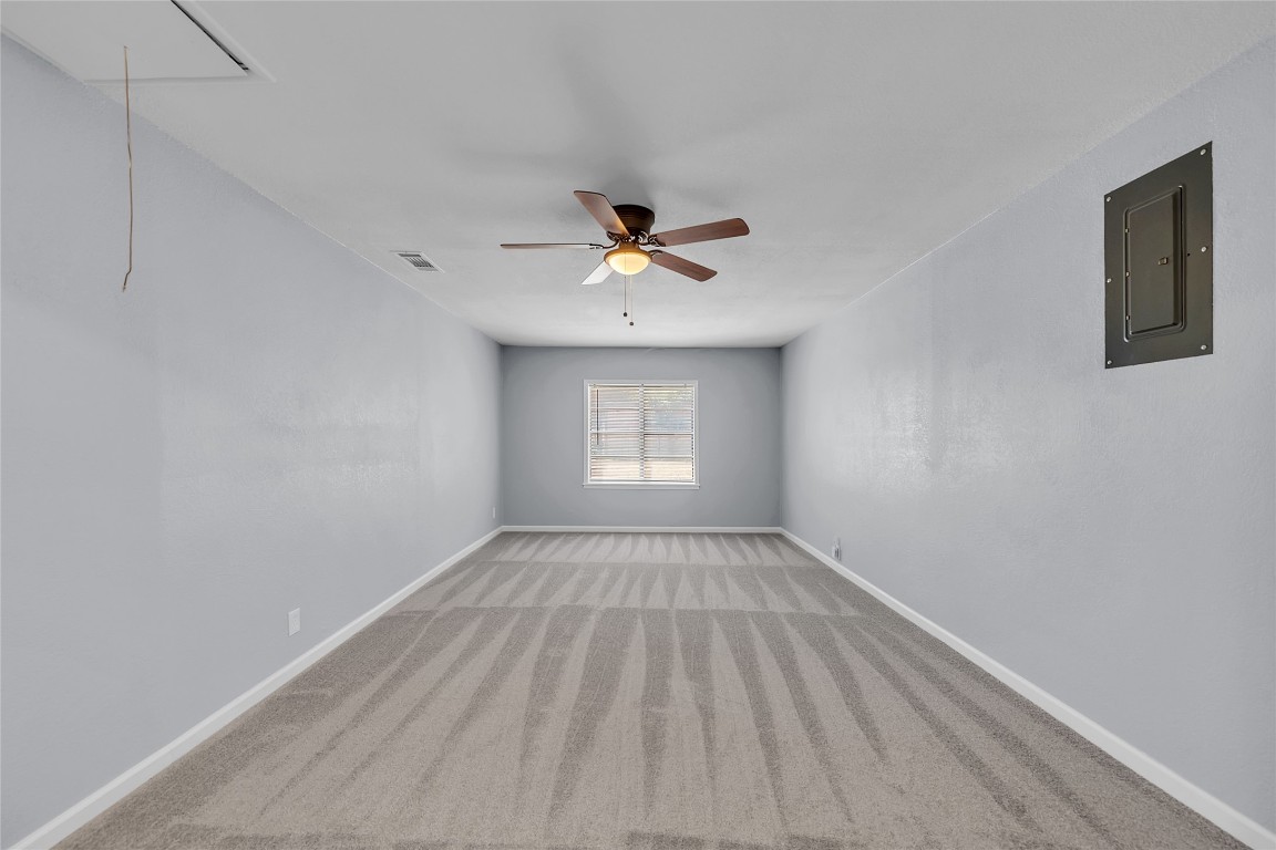 310 Hruskaville Road Temple, TX 76501 - Photo 19 of 21 Carpeted spare room featuring attic access, electric panel, and a ceiling fan