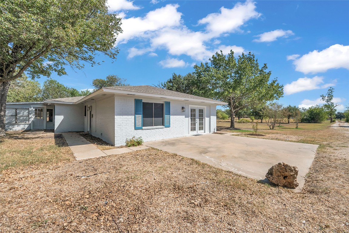 310 Hruskaville Road Temple, TX 76501 - Photo 7 of 21 Rear view of house featuring french doors, brick siding, and a patio