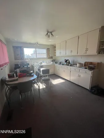 a kitchen with a sink cabinets and window