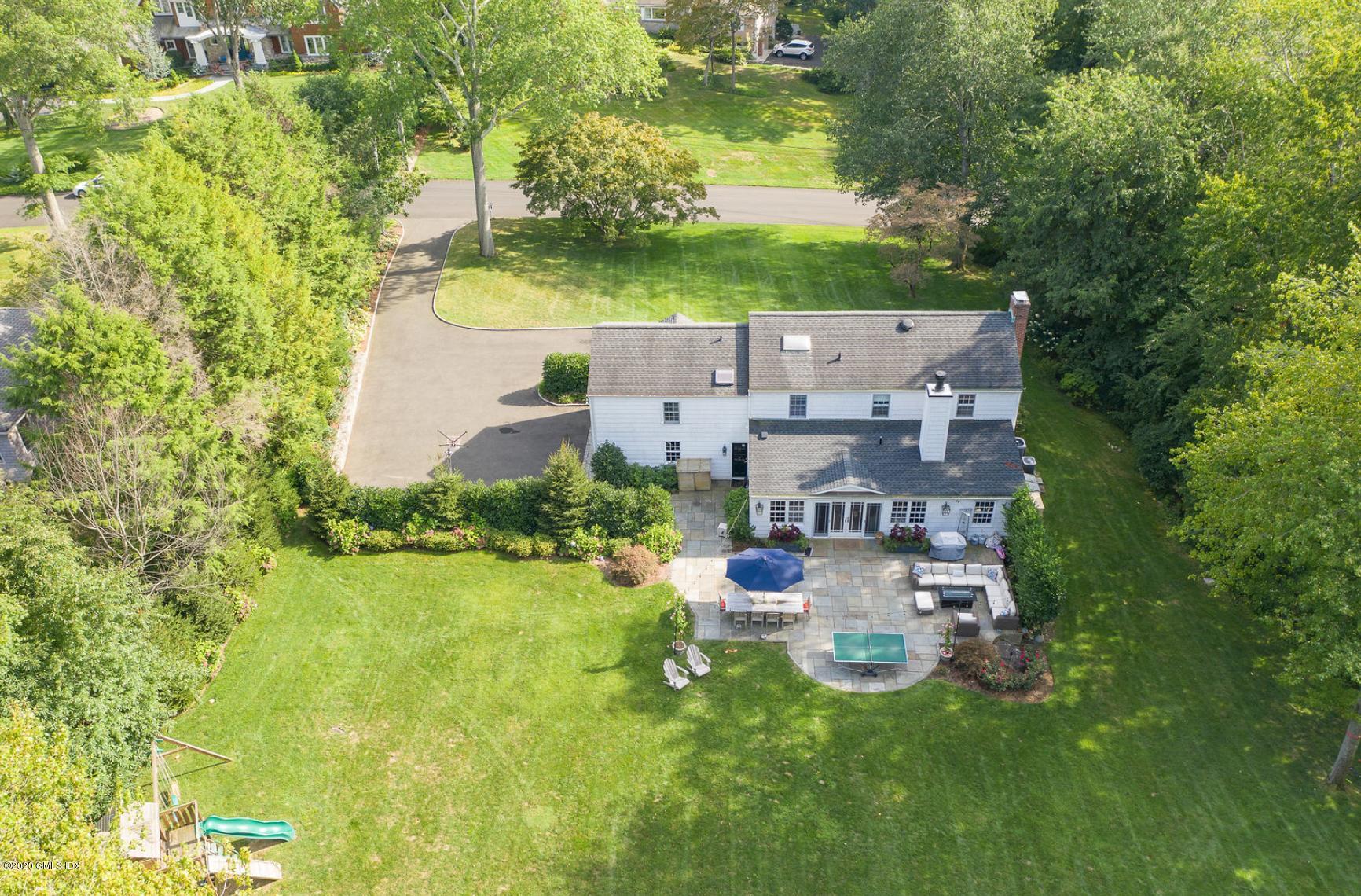 an aerial view of a house with garden space and street view