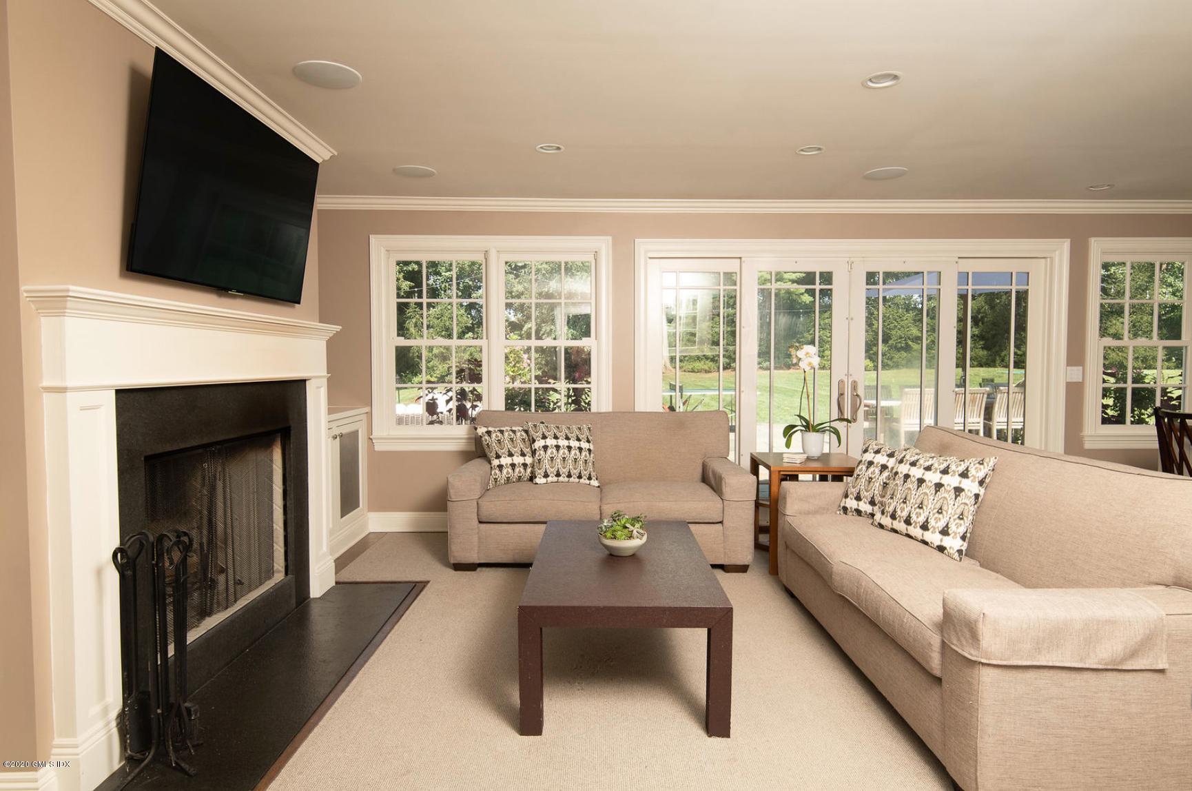 88 Birch Lane Greenwich, CT 06830 - Photo 17 of 33 a living room with furniture a fireplace and a flat screen tv