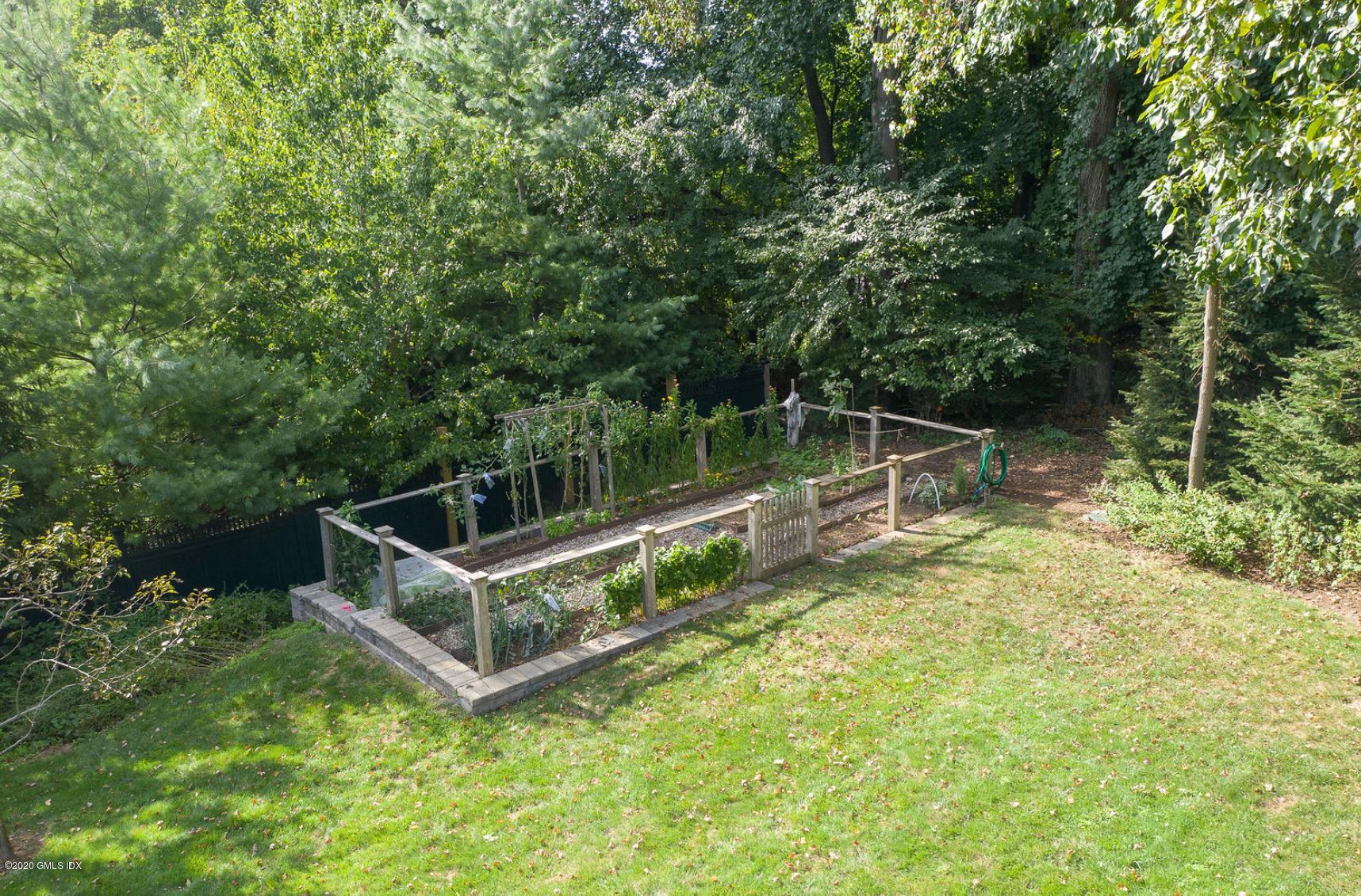 88 Birch Lane Greenwich, CT 06830 - Photo 28 of 33 a view of a house with a backyard and a small park