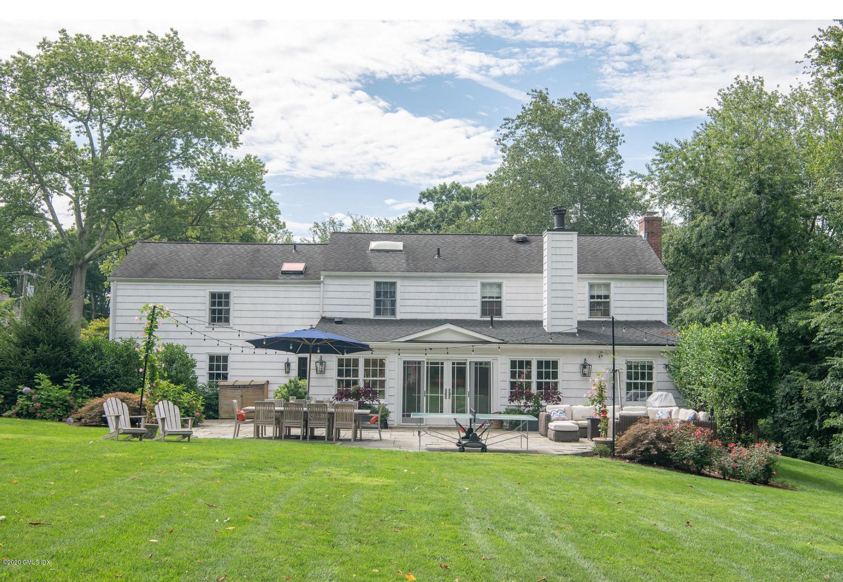 88 Birch Lane Greenwich, CT 06830 - Photo 4 of 33 a front view of a house with a garden and trees