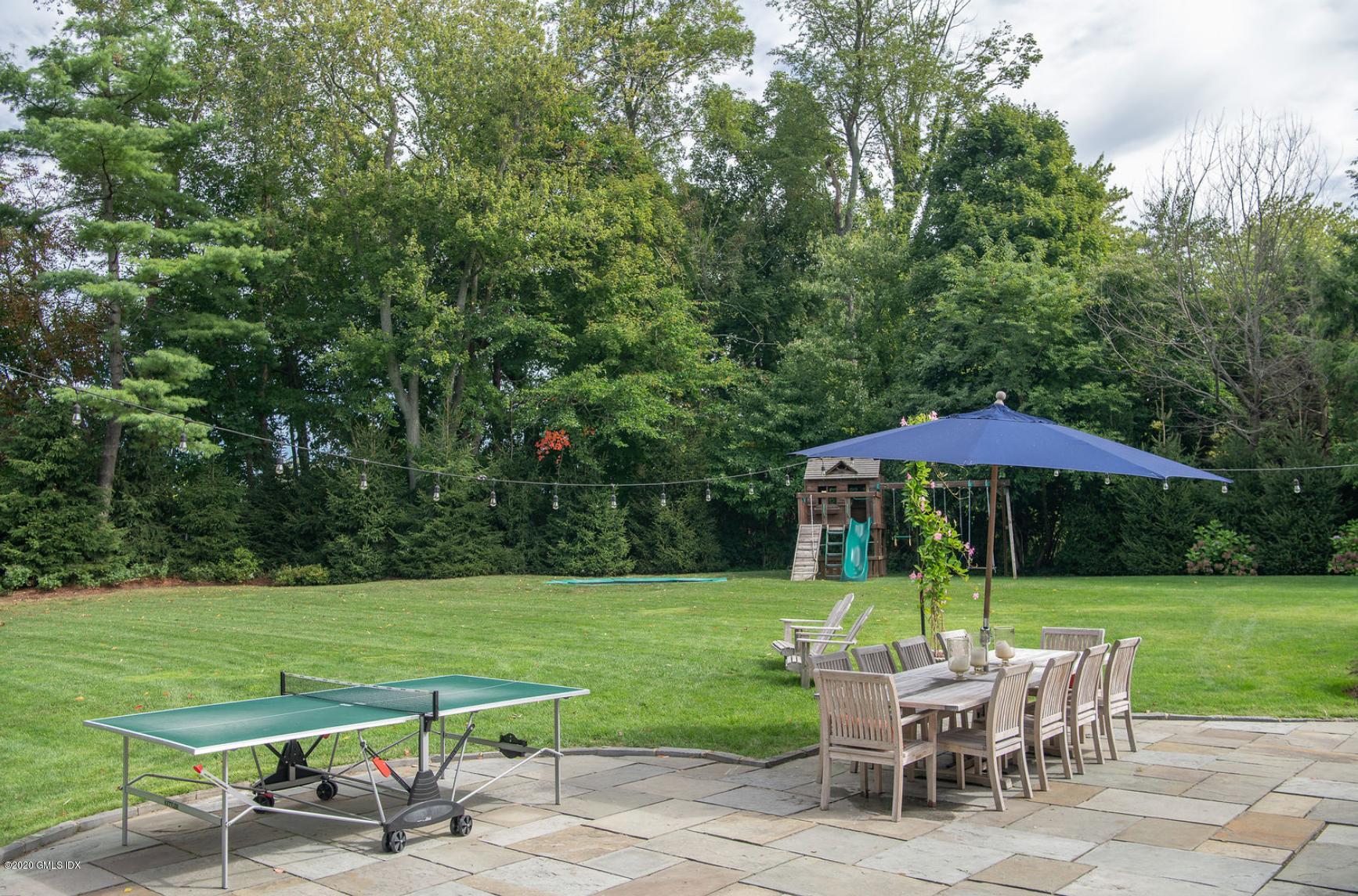 88 Birch Lane Greenwich, CT 06830 - Photo 7 of 33 a view of a table and chairs in backyard of the house