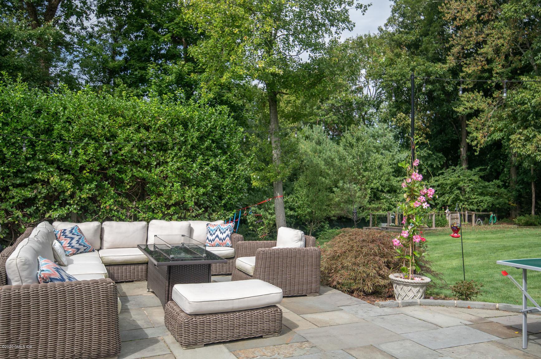 88 Birch Lane Greenwich, CT 06830 - Photo 8 of 33 a view of a patio with couches and a table and chairs with garden view