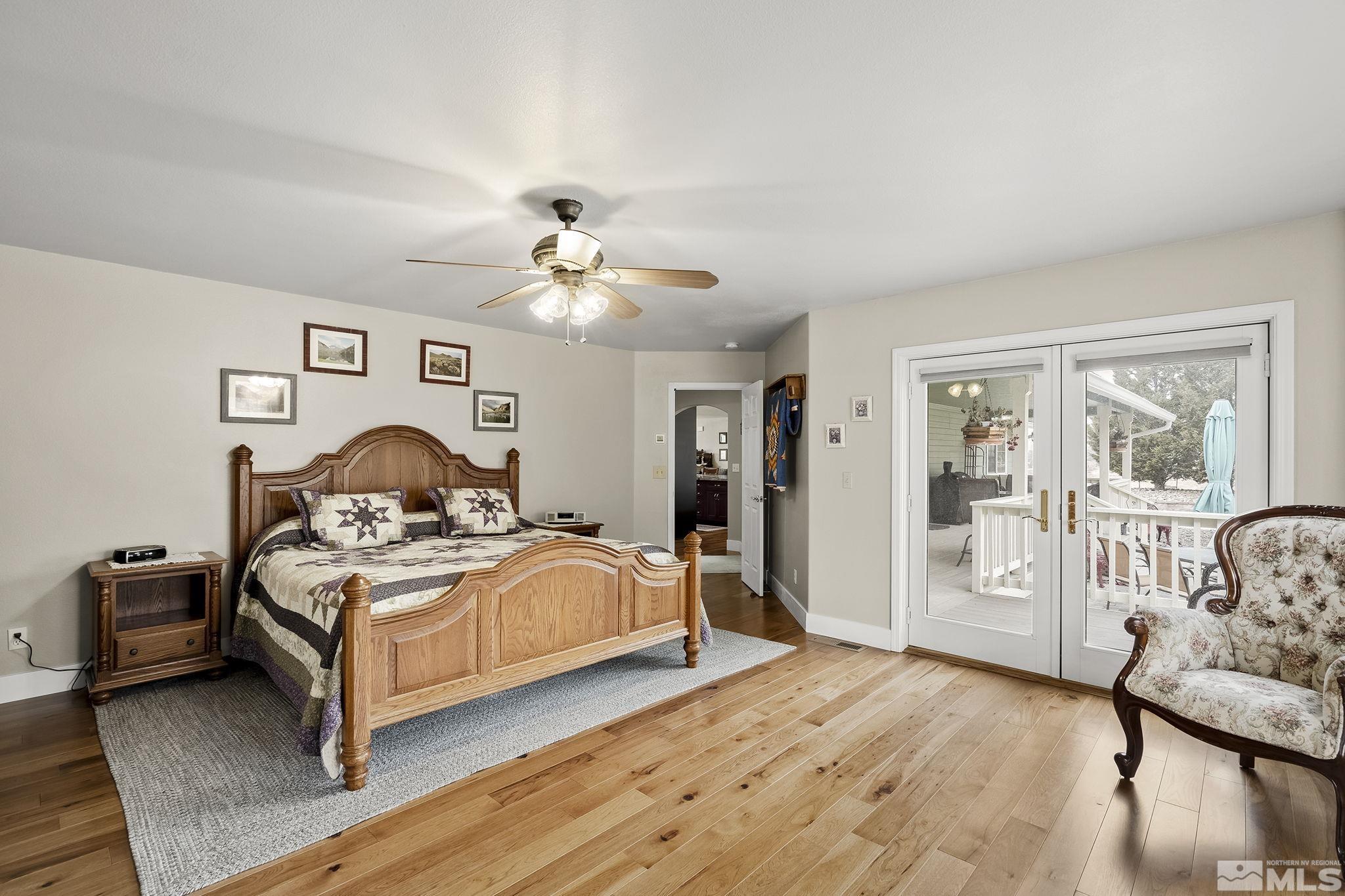 15025 North Red Rock Road Reno, NV 89508 - Photo 29 of 40 a bedroom with a bed and wooden floor