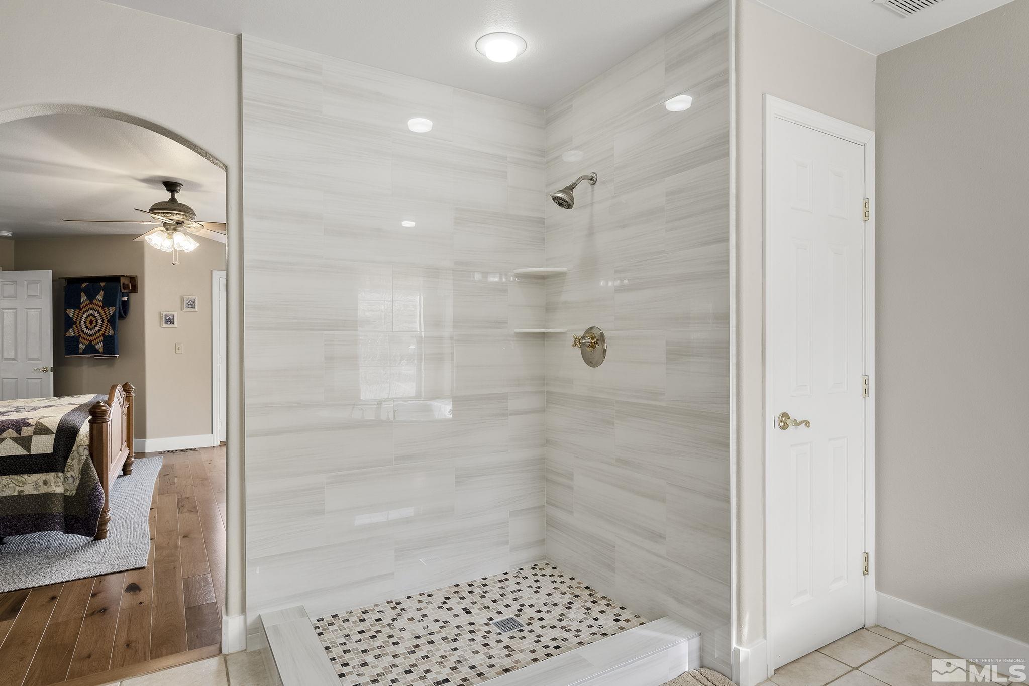 15025 North Red Rock Road Reno, NV 89508 - Photo 31 of 40 a bathroom with a glass shower door