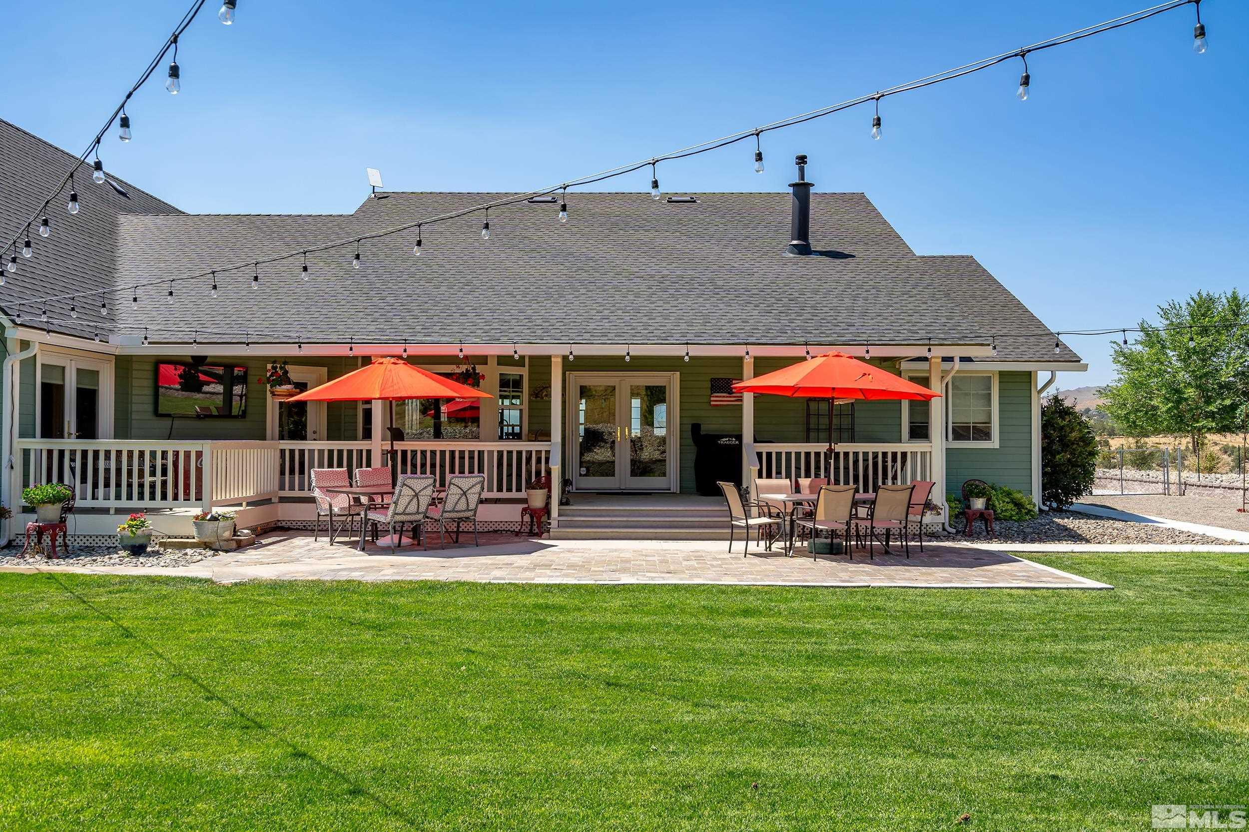 15025 North Red Rock Road Reno, NV 89508 - Photo 4 of 40 a patio with a table and chairs under an umbrella