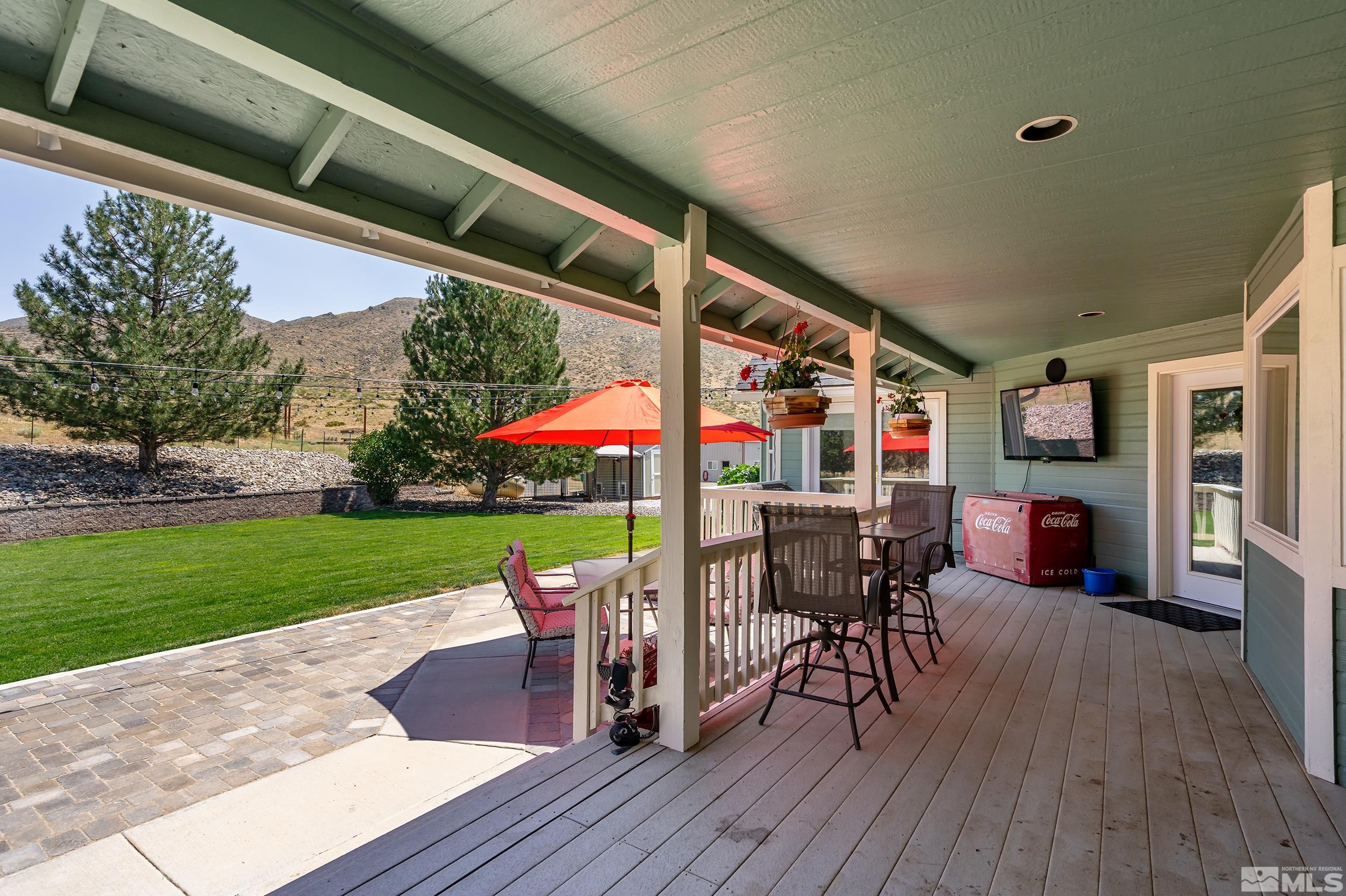 15025 North Red Rock Road Reno, NV 89508 - Photo 7 of 40 a view of a patio with table and chairs potted plants with wooden floor