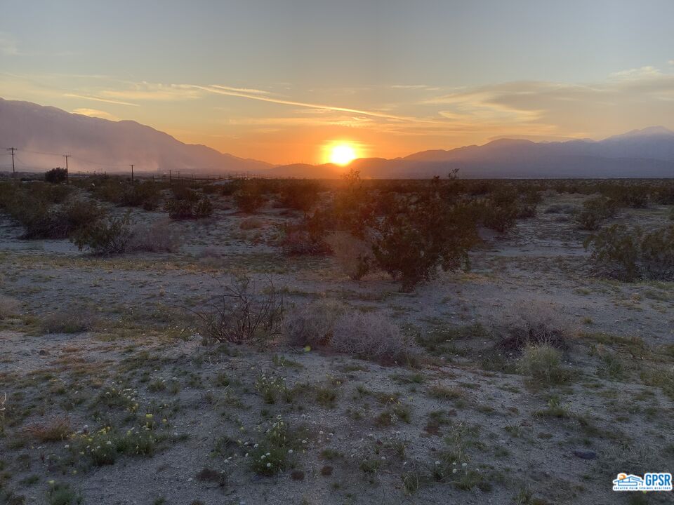 70777 Dillon Road Desert Hot Springs, CA 92241 - Photo 5 of 5 a view of a dry yard with mountains in the background