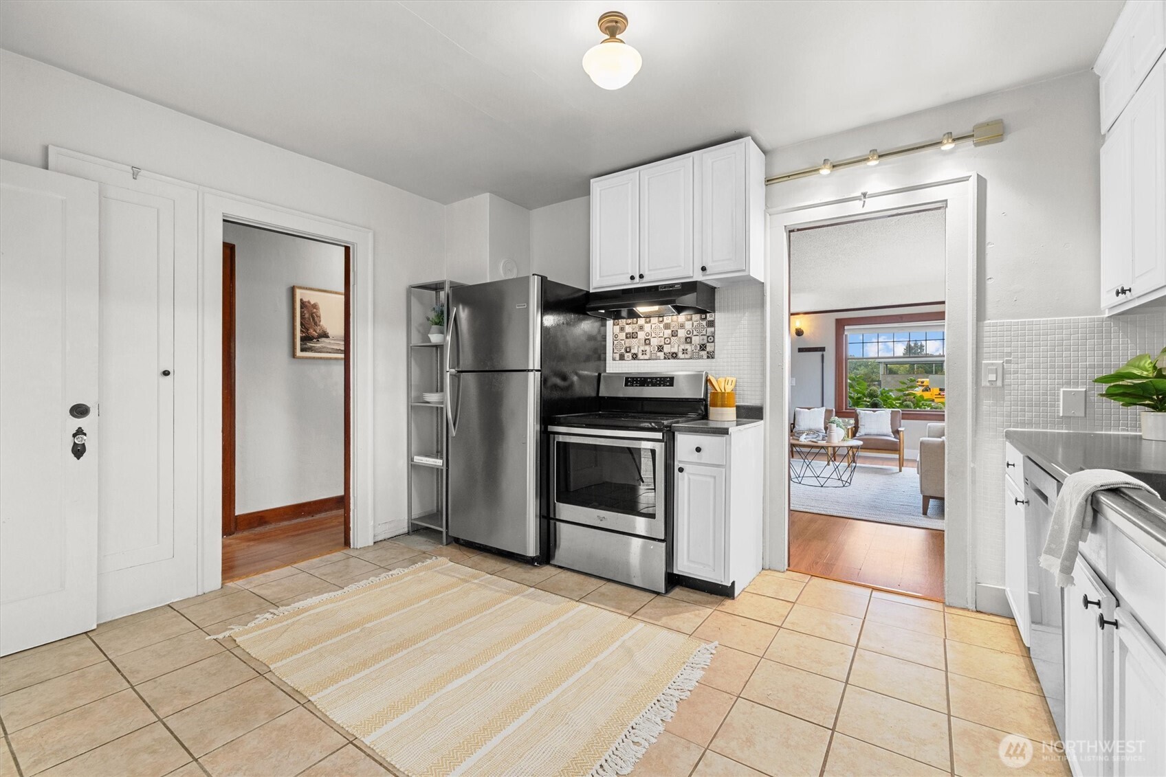 1211 North 3rd Street Renton, WA 98057 - Photo 12 of 40 a kitchen with stainless steel appliances a stove a refrigerator and cabinets
