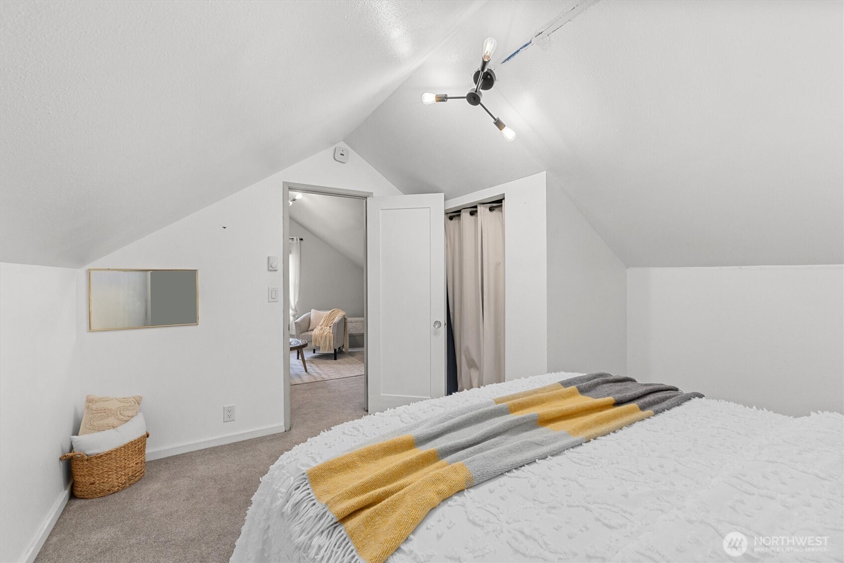 1211 North 3rd Street Renton, WA 98057 - Photo 16 of 40 a bedroom with a bed and a chandelier