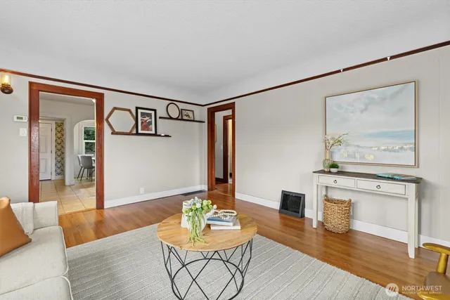 a living room with furniture and wooden floor