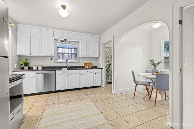 a kitchen with stainless steel appliances a refrigerator sink and cabinets