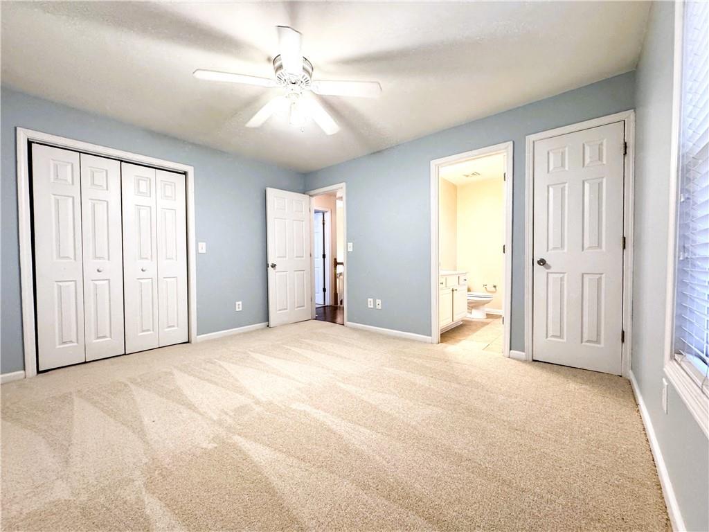 112 Summer Place Northwest Norcross, GA 30071 - Photo 19 of 24 a view of empty room with windows and chandelier fan