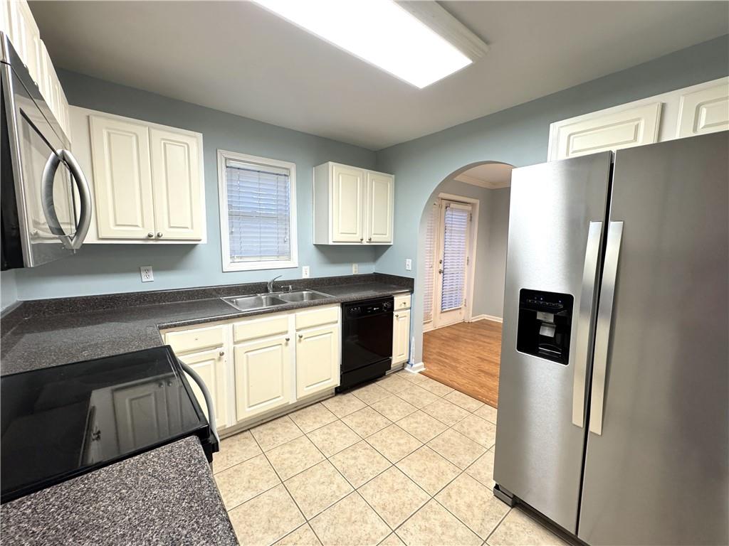 112 Summer Place Northwest Norcross, GA 30071 - Photo 7 of 24 a kitchen with stainless steel appliances granite countertop a refrigerator a sink a stove a microwave and island