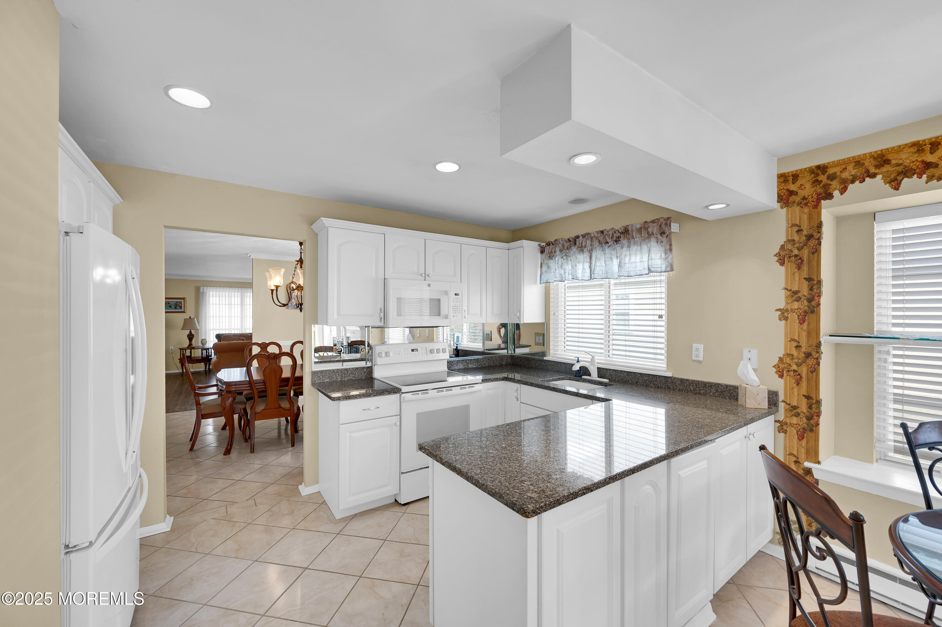 41 Red Hill Road Manchester Township, NJ 08759 - Photo 23 of 39 a kitchen with a sink table and chairs
