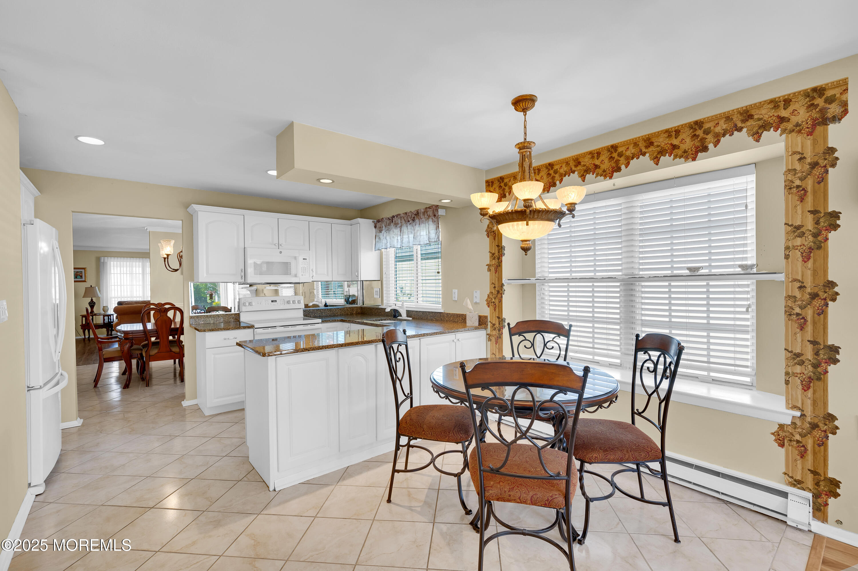 41 Red Hill Road Manchester Township, NJ 08759 - Photo 27 of 39 a kitchen with a dining table chairs and a refrigerator