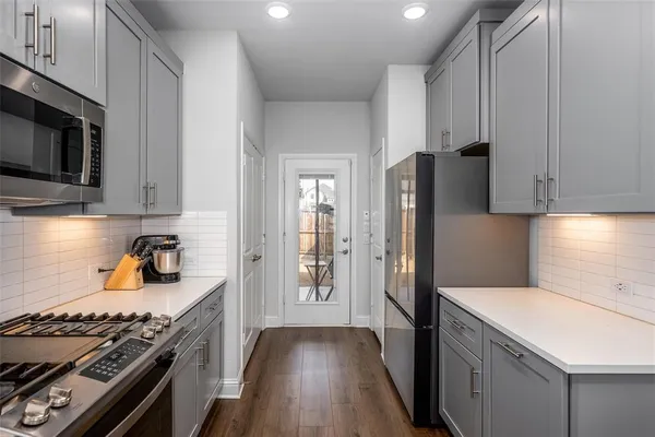 a kitchen with a stove and a refrigerator