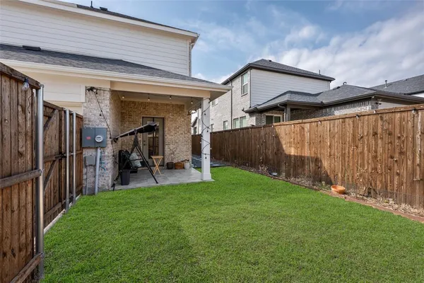 a view of a backyard with wooden fence and a stairs