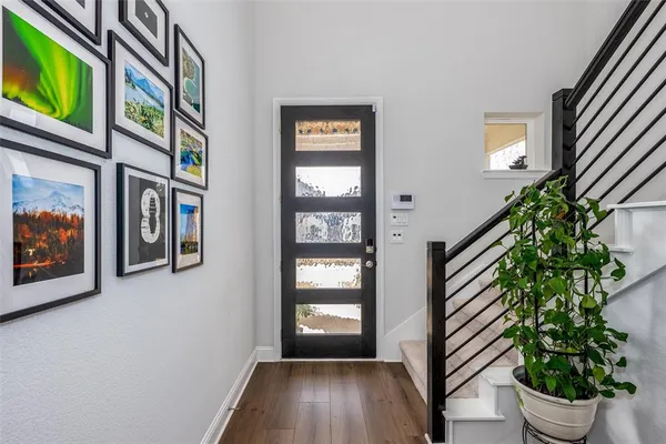 a view of an entryway with wooden floor and front door