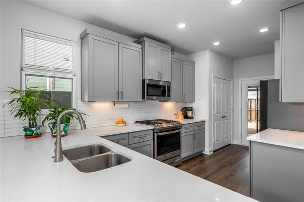 a kitchen that has a sink and a stove in it