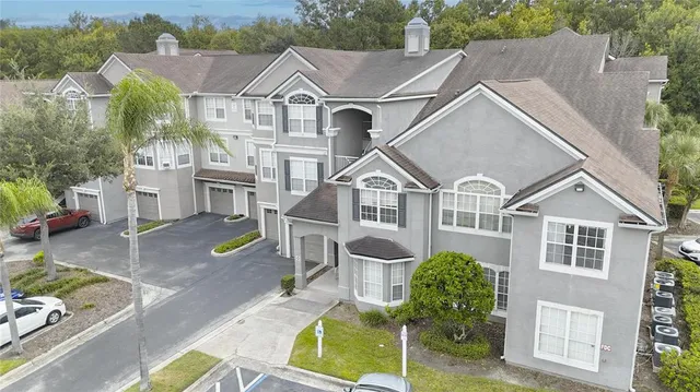 an aerial view of a house with a yard