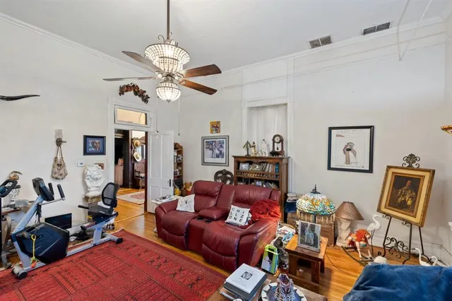 a living room with furniture a air conditioner and a window