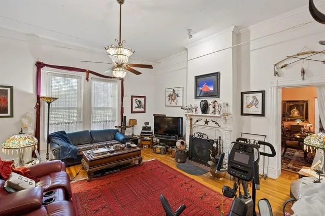 a living room with furniture a rug and a chandelier
