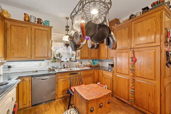 a kitchen with stainless steel appliances granite countertop a sink and a refrigerator