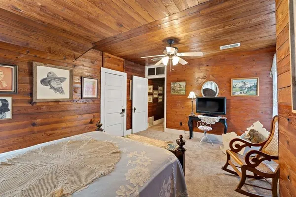 a bed room with a bed and a chandelier
