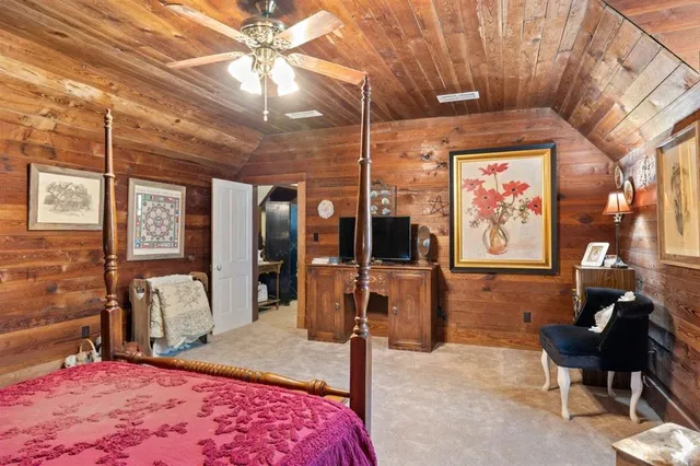 a bedroom with furniture and a flat screen tv